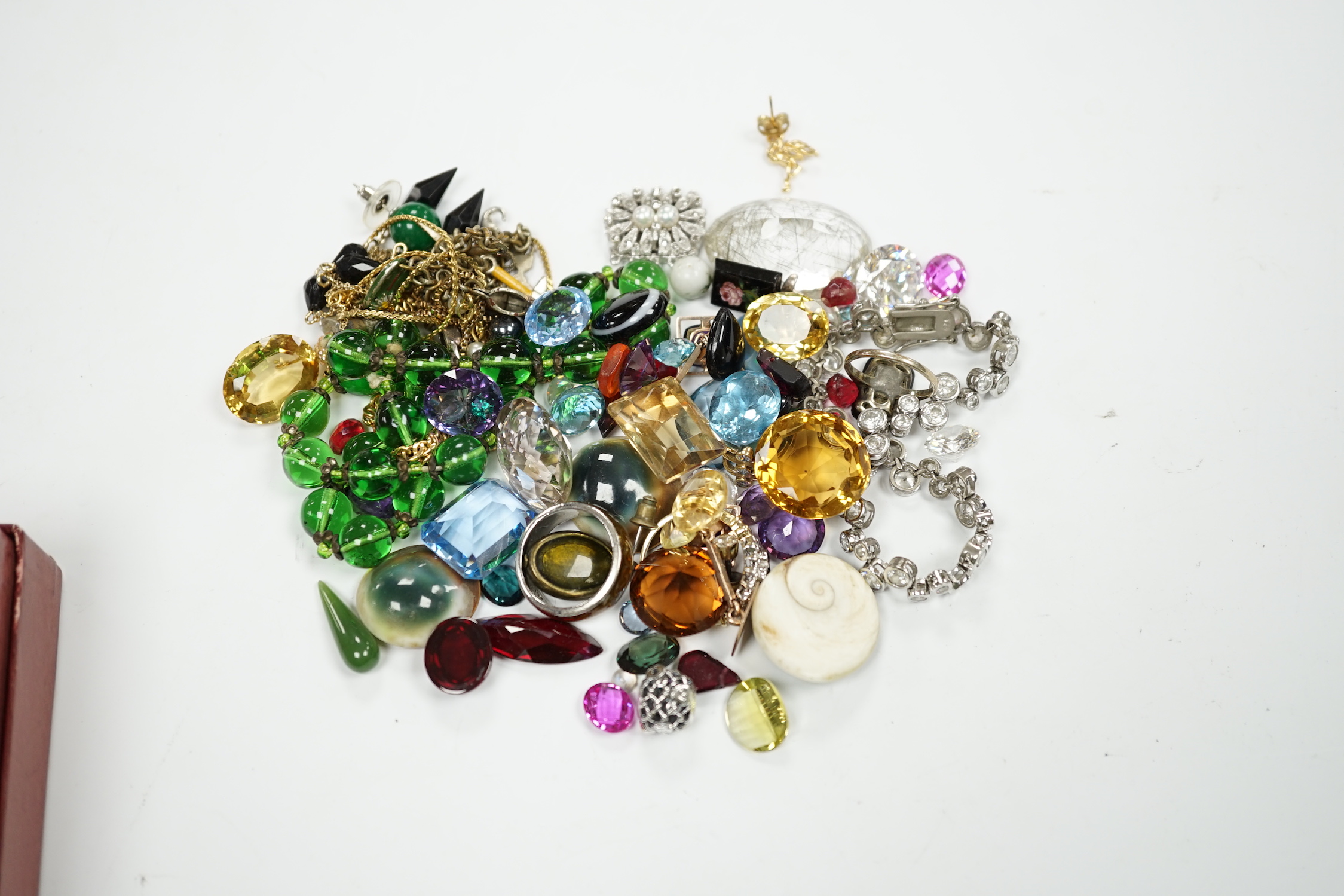 Assorted unmounted cut gemstones including rutilated quartz and other costume jewellery including 925 and paste set tennis bracelet and a 9ct gold ring, etc.